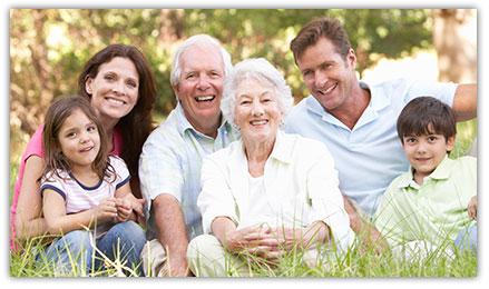 family sitting in field